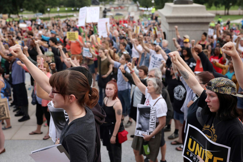<p>Supporters of Philando Castile hold their fists up in solidarity during a gathering Friday, June 16, 2017, outside the state Capitol in St. Paul, Minn. The vigil was held after St. Anthony police Officer Jeronimo Yanez was cleared Friday in the fatal shooting of Castile last year. (Anthony Souffle/Star Tribune via AP) </p>