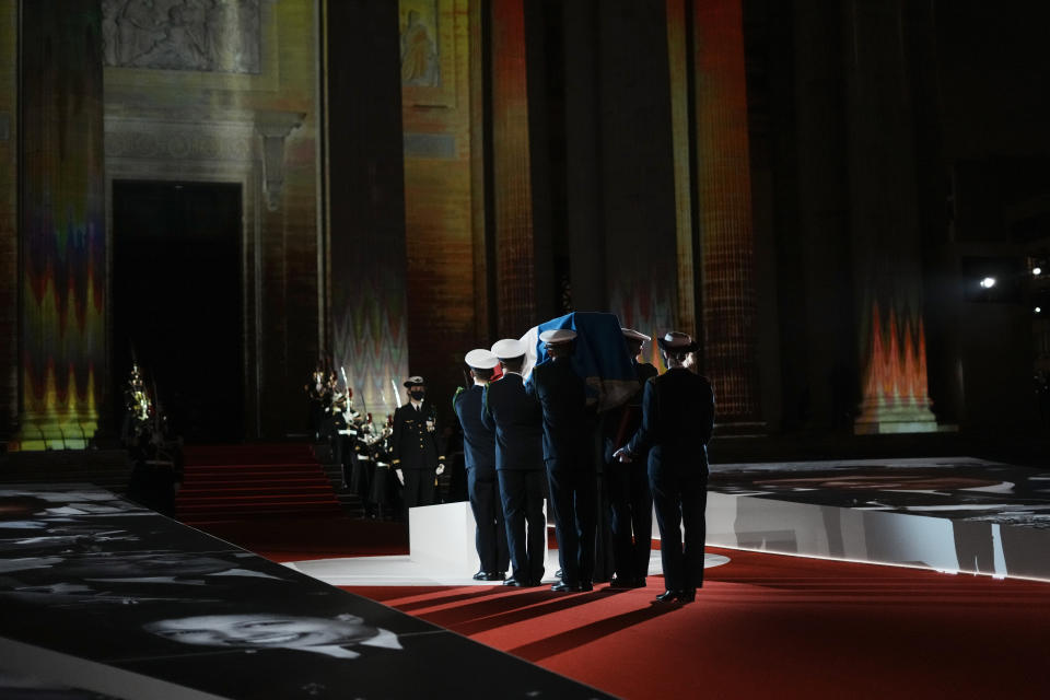 Six carriers of the Air Force and Space carry the cenotaph of Josephine Baker, covered with the French flag, into the Pantheon in Paris, France, Tuesday, Nov. 30, 2021, where she is to symbolically be inducted, becoming the first Black woman to receive France's highest honor. Her body will stay in Monaco at the request of her family. (Thibault Camus/Pool Photo via AP)