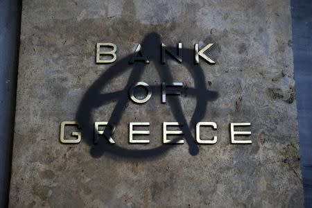 An anarchy symbol is spray-painted over the logo of Bank of Greece in Athens May 1, 2015. REUTERS/Alkis Konstantinidis