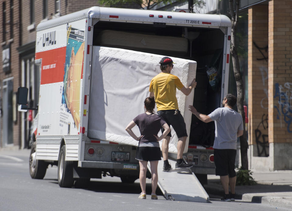 People load a truck with belongings in Montreal. THE CANADIAN PRESS/Graham Hughes