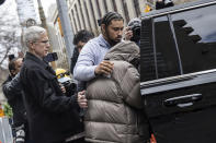 British billionaire Joe Lewis, covered in a jacket, leaves Manhattan Federal court, Thursday, April 4, 2024, in New York. Lewis, whose family trust owns the Tottenham Hotspur soccer club, will not spend any time in prison after he pleaded guilty to insider trading and conspiracy charges in New York, a federal judge said Thursday. (AP Photo/Jeenah Moon)
