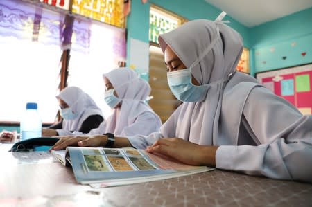 Students cover their faces with masks at a school in Puchong as haze shrouds Kuala Lumpur