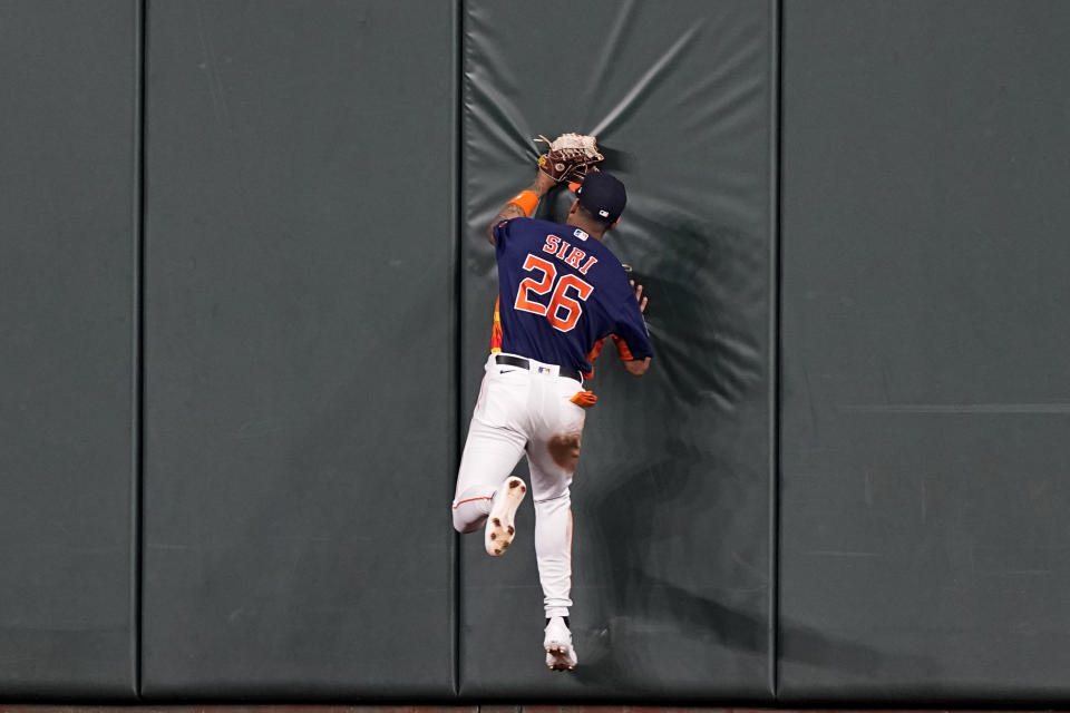 Houston Astros center fielder Jose Siri hits the wall after catching a fly ball by Miami Marlins' Bryan De La Cruz during the fifth inning of a baseball game Sunday, June 12, 2022, in Houston. (AP Photo/David J. Phillip)