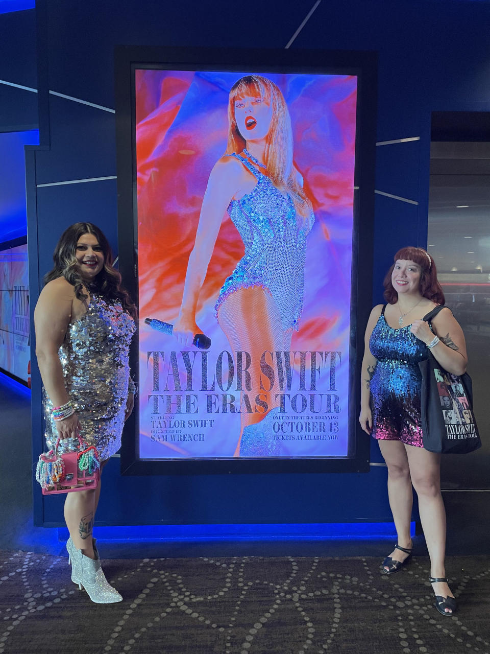 Two women pose in front of a Taylor Swift poster (Ariana Brockington / TODAY)
