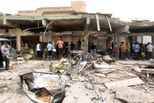 Iraqis walk through the rubble of a liquor store that was targetted in a car bomb attack in Baghdad on July 28. Iraq is a less safe place than it was one year ago as security continues to deteriorate, an American watchdog warned on Saturday, just months ahead of a US withdrawal from the country