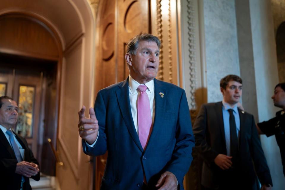 Sen. Joe Manchin, D-W.Va., chairman of the Senate Energy and Natural Resources Committee, speaks to a colleague just outside the chamber, at the Capitol in Washington, Tuesday, June 13, 2023.