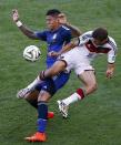 Germany's Thomas Muelle (R) fights for the ball with Argentina's Marcos Rojo during their 2014 World Cup final at the Maracana stadium in Rio de Janeiro July 13, 2014. REUTERS/Leonhard Foeger (BRAZIL - Tags: SOCCER SPORT WORLD CUP)