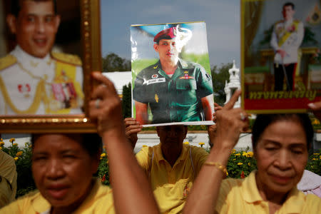 People hold photos of Thailand's newly crowned King Maha Vajiralongkorn before a coronation procession, near the Grand Palace in Bangkok, Thailand May 5, 2019. REUTERS/Navesh Chitrakar