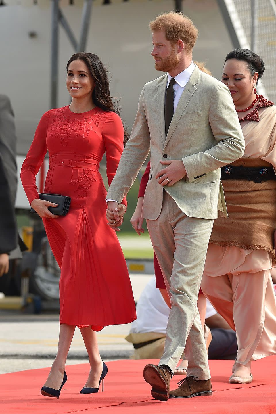 <p><strong>25 October </strong>The royals arrived in Tonga. Prince Harry wore a beige linen suit, while Meghan opted for a <a rel="nofollow noopener" href="https://www.harrods.com/en-gb/self-portrait/pleated-floral-gown-p000000000006142966?&ranMID=36666&ranEAID=QFGLnEolOWg&ranSiteID=QFGLnEolOWg-M9aIDBIyaOmGJJVQhRDzuA&cid=LS&utm_source=Affiliate&utm_medium=RakutenAffiliate&utm_campaign=QFGLnEolOWg&utm_content=15&siteID=QFGLnEolOWg-M9aIDBIyaOmGJJVQhRDzuA" target="_blank" data-ylk="slk:red Self-Portrait dress;elm:context_link;itc:0;sec:content-canvas" class="link ">red Self-Portrait dress</a>, Dior bag and <a rel="nofollow noopener" href="https://www.barneys.com/product/manolo-blahnik-bb-pumps-503345489.html?ranMID=38359&ranEAID=QFGLnEolOWg&ranSiteID=QFGLnEolOWg-ACkMil3sv_fPadc7yGLY6g&utm_source=QFGLnEolOWg&utm_medium=affiliate&utm_campaign=1&utm_content=621860&siteID=QFGLnEolOWg-ACkMil3sv_fPadc7yGLY6g" target="_blank" data-ylk="slk:Manolo Blahnik pumps;elm:context_link;itc:0;sec:content-canvas" class="link ">Manolo Blahnik pumps</a>.</p><p><a rel="nofollow noopener" href="https://www.harrods.com/en-gb/self-portrait/pleated-floral-gown-p000000000006142966?&ranMID=36666&ranEAID=QFGLnEolOWg&ranSiteID=QFGLnEolOWg-M9aIDBIyaOmGJJVQhRDzuA&cid=LS&utm_source=Affiliate&utm_medium=RakutenAffiliate&utm_campaign=QFGLnEolOWg&utm_content=15&siteID=QFGLnEolOWg-M9aIDBIyaOmGJJVQhRDzuA" target="_blank" data-ylk="slk:SHOP THE DRESS;elm:context_link;itc:0;sec:content-canvas" class="link ">SHOP THE DRESS</a></p><p><a rel="nofollow noopener" href="https://www.barneys.com/product/manolo-blahnik-bb-pumps-503345489.html?ranMID=38359&ranEAID=QFGLnEolOWg&ranSiteID=QFGLnEolOWg-ACkMil3sv_fPadc7yGLY6g&utm_source=QFGLnEolOWg&utm_medium=affiliate&utm_campaign=1&utm_content=621860&siteID=QFGLnEolOWg-ACkMil3sv_fPadc7yGLY6g" target="_blank" data-ylk="slk:SHOP THE SHOES;elm:context_link;itc:0;sec:content-canvas" class="link ">SHOP THE SHOES </a></p>