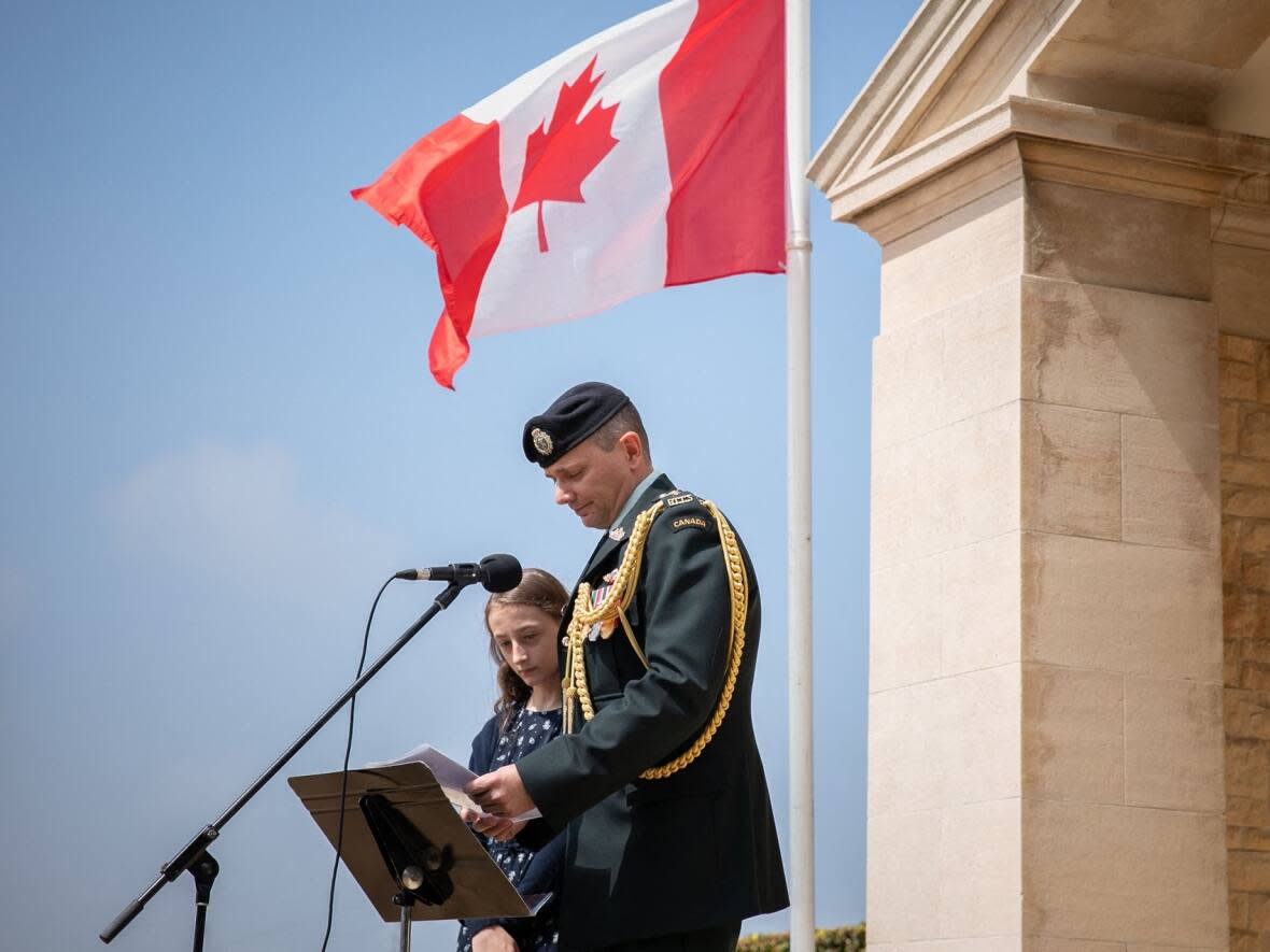 Participants deliver names of the late soldiers during the commemoration of the 80th anniversary of Operation Jubilee at the Dieppe Canadian War Cemetery, in Hautot-sur-Mer, northwestern France, on Aug. 18, 2022. (Lou Benoist/AFP/Getty Images - image credit)