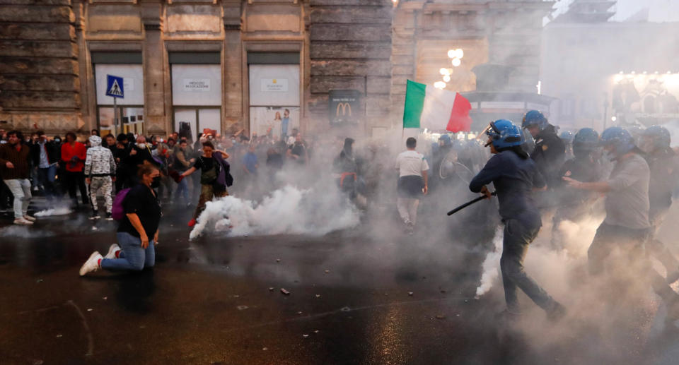 Demonstrators clash with police officers during a protest against the government's introduction of the 