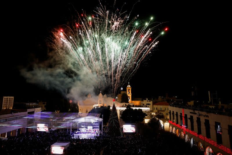 Palestinians light a Christmas tree in Bethlehem