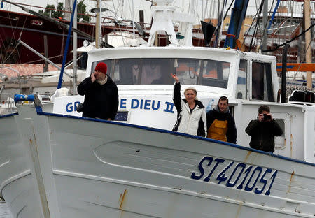 Marine Le Pen (2ndL), French National Front (FN) political party candidate for French 2017 presidential election, waves from a fishing boat after an excursion during a campaign visit to the port in Le Grau-du-Roi, France, April 27, 2017. REUTERS/Jean-Paul Pelissier