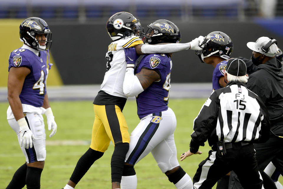 Baltimore Ravens outside linebacker Matt Judon, center, pushes Pittsburgh Steelers wide receiver Diontae Johnson, center left, away during an altercation with Ravens cornerback Marcus Peters, center right, during the first half of an NFL football game, Sunday, Nov. 1, 2020, in Baltimore. (AP Photo/Nick Wass)