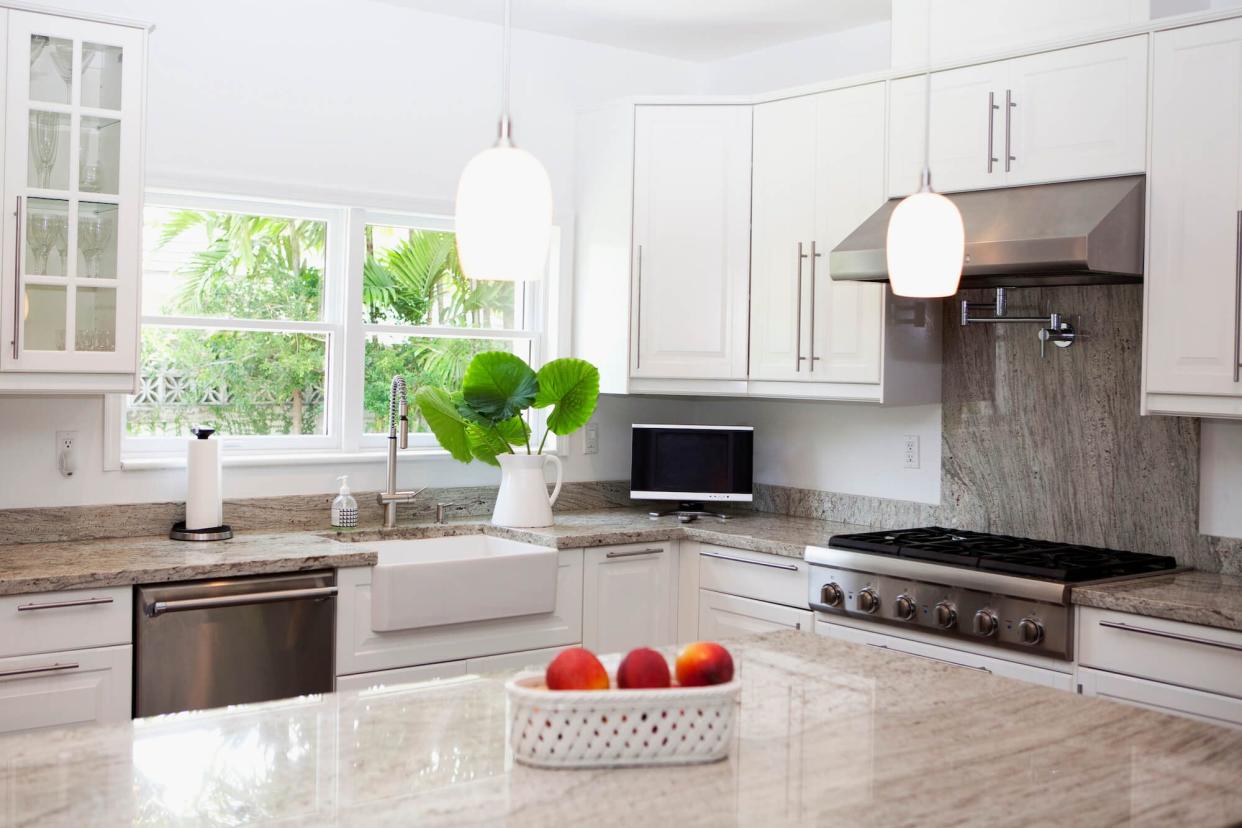 A kitchen with a sink full of natural light