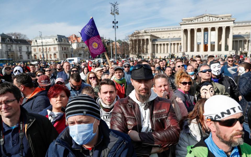 People attend a demonstration against the coronavirus disease (COVID-19) measures and their economic consequences, at Heroes' Square in Budapest, Hungary - REUTERS/Bernadett Szabo