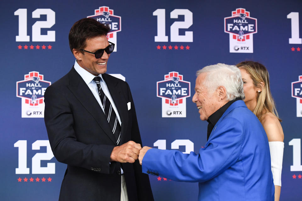 Tom Brady and Robert Kraft are seen fist bumping at Brady's Hall of Fame induction ceremony