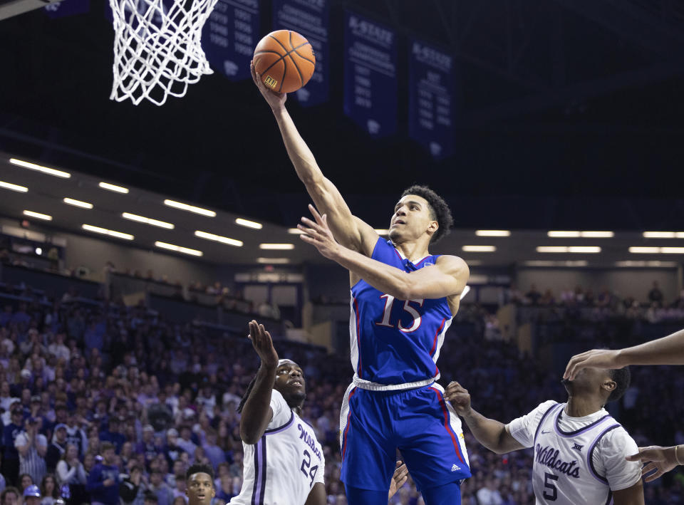 Kansas' Kevin McCullar Jr. (15) shoots over Kansas State's Arthur Kaluma (24) during the first half of an NCAA college basketball game Monday, Feb. 5, 2024, in Manhattan, Kan. (Travis Heying/The Wichita Eagle via AP)