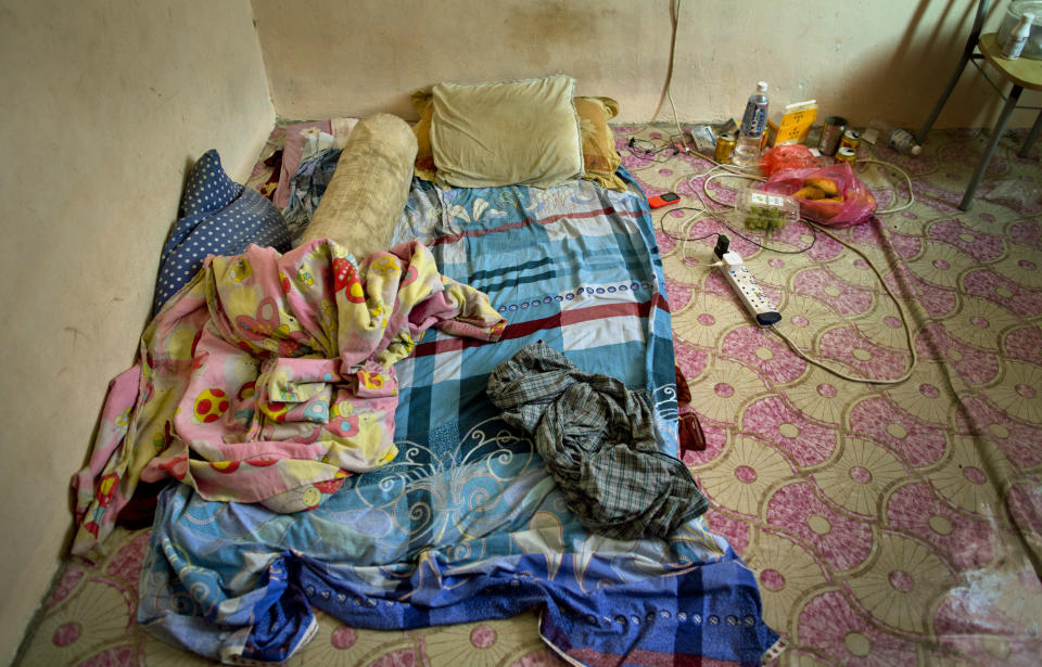 Pillows and blankets are seen in the sleeping area of Bangladeshi palm oil worker, Karim, at a house he shares with others in peninsular Malaysia, Wednesday, March 6, 2019. "I have been cheated five times in six years," said Karim, a migrant worker who arrived in Malaysia legally after being promised a position in an electronics company, only to end up working for a subcontractor on several plantations owned by the biggest companies. He says once when he asked for his unpaid wages, his boss "threatened to run me over with his car." (AP Photo/Gemunu Amarasinghe)