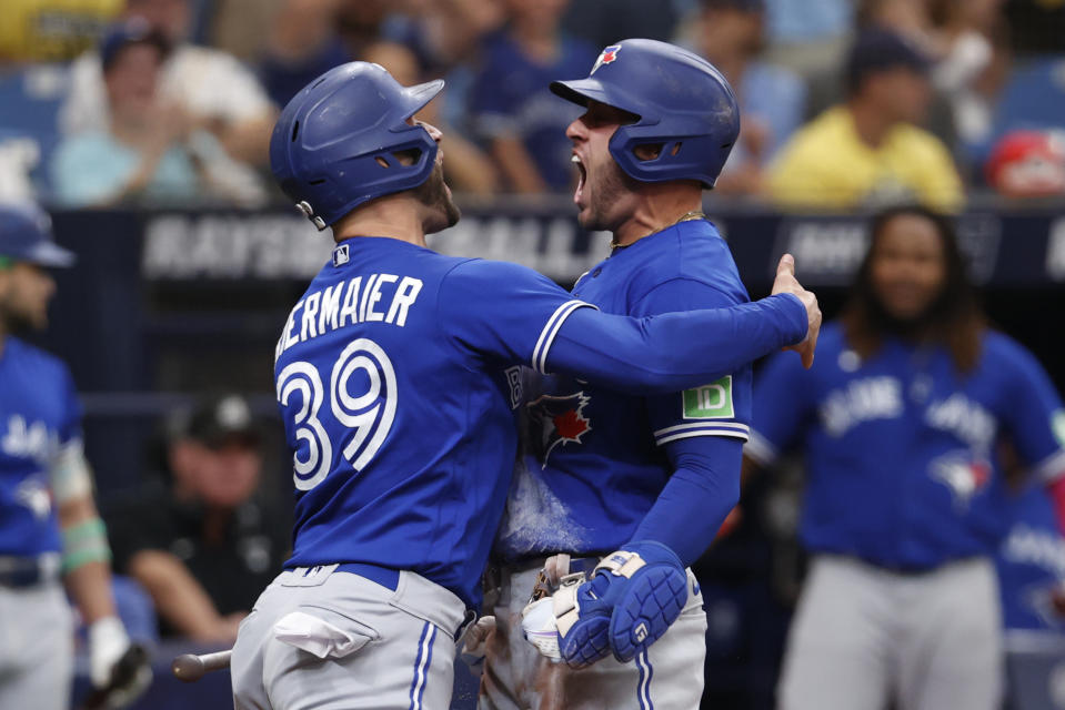 Toronto Blue Jays' George Springer, right, celebrates with the Jays' Kevin Kiermaier after hitting a three-run home run against the Tampa Bay Rays during the second inning of a baseball game Sunday, Sept. 24, 2023, in St. Petersburg, Fla. (AP Photo/Scott Audette)