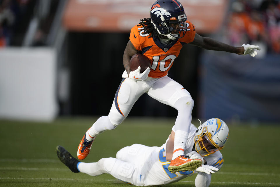 Denver Broncos wide receiver Jerry Jeudy (10) runs past Los Angeles Chargers safety Alohi Gilman (32) after making a catch during the first half of an NFL football game in Denver, Sunday, Jan. 8, 2023. (AP Photo/David Zalubowski)