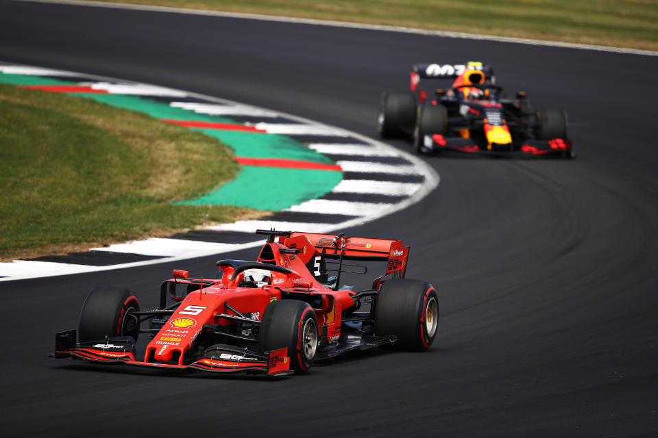 NORTHAMPTON, ENGLAND - JULY 14: Sebastian Vettel of Germany driving the (5) Scuderia Ferrari SF90 leads Pierre Gasly of France driving the (10) Aston Martin Red Bull Racing RB15 on track during the F1 Grand Prix of Great Britain at Silverstone on July 14, 2019 in Northampton, England. (Photo by Bryn Lennon/Getty Images)