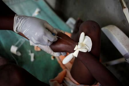 A boy receives a drip to be treated for cholera after Hurricane Matthew in the Hospital of Port-a-Piment, Haiti, October 9, 2016. REUTERS/Andres Martinez Casares