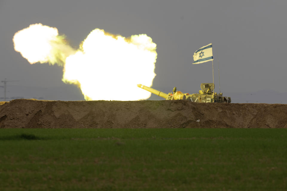 An Israeli mobile artillery unit fires a shell from southern Israel towards the Gaza Strip, in a position near the Israel-Gaza border on Thursday, Dec. 21, 2023. (AP Photo/Ohad Zwigenberg)