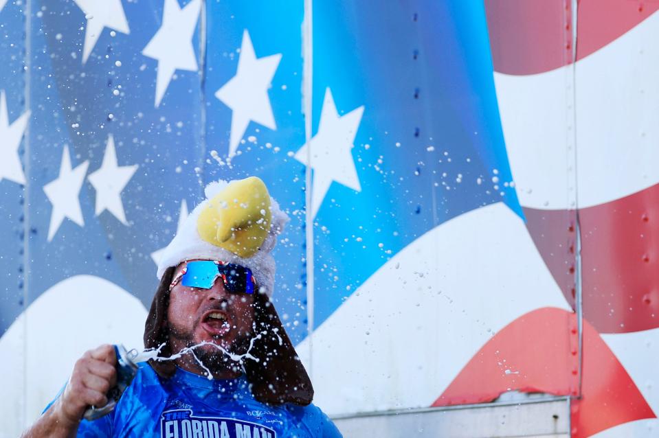 Larry Donnelly of St. Augustine double fists two beers as team “Hanky Spanky” is announced the victor of the competition during the awards ceremony during the inaugural Florida Man Games Saturday, Feb. 24, 2024 at Francis Field in St. Augustine, Fla. Hundreds turned out to witness the Floridian Olympic-style events. Team “Hanky Spanky,” based out of St. Augustine, would take home the championship belt. [Corey Perrine/Florida Times-Union]