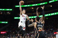 Miami Heat guard Tyler Herro shoots over Atlanta Hawks forward John Collins and forward Onyeka Okongwu during the second half of an NBA basketball game, Sunday, Nov. 27, 2022, in Atlanta. (AP Photo/Hakim Wright Sr.)