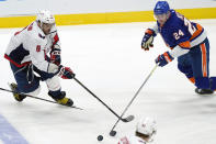 New York Islanders defenseman Scott Mayfield (24) and Washington Capitals left wing Alex Ovechkin (8) go after the puck during the second period of an NHL hockey game Thursday, April 22, 2021, in Uniondale, N.Y. (AP Photo/Kathy Willens)