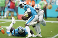 Miami Dolphins defensive end Emmanuel Ogbah (91) sacks Carolina Panthers quarterback P.J. Walker (6) during the second half of an NFL football game, Sunday, Nov. 28, 2021, in Miami Gardens, Fla. Top the left is Carolina Panthers offensive tackle Taylor Moton (72). (AP Photo/Wilfredo Lee)