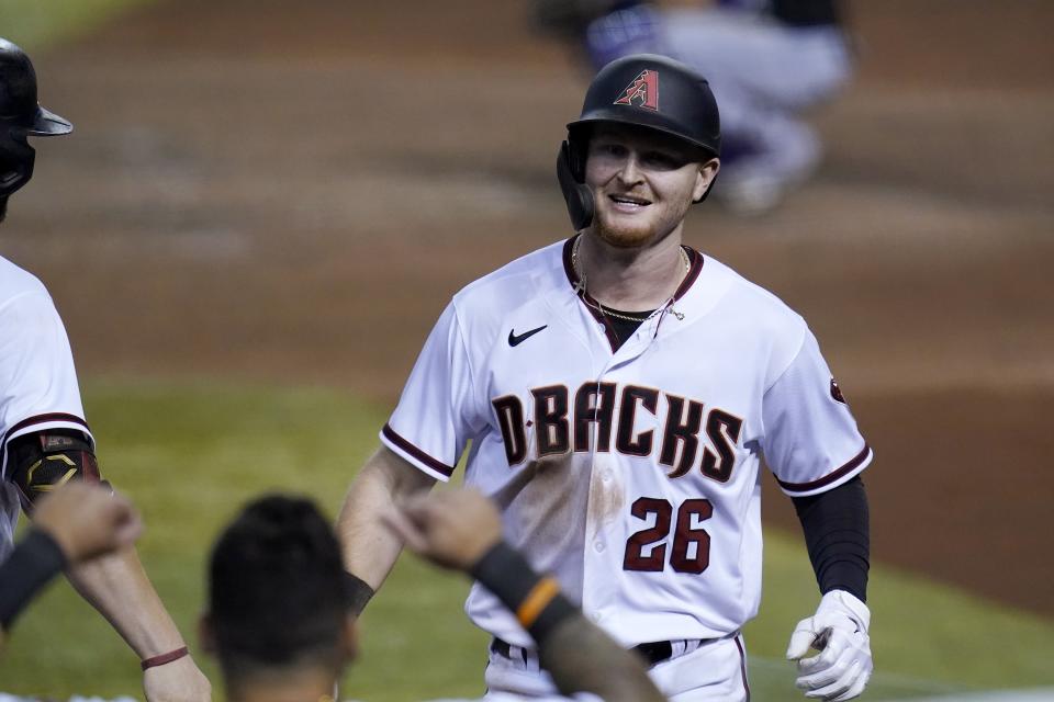 Arizona Diamondbacks' Pavin Smith (26) smiles after his home run against the Colorado Rockies during the fifth inning of the second game of a baseball doubleheader Friday, Sept. 25, 2020, in Phoenix. (AP Photo/Ross D. Franklin)