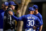 Comedian and actor Will Ferrell, left, talks with Los Angeles Dodgers manager Dave Roberts, right, during spring training baseball workouts Sunday, March 10, 2024, in Phoenix. (AP Photo/Lindsey Wasson)