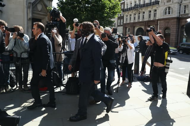 Actor Johnny Depp, centre, arriving at the High Court in London for a hearing in his libel case against the publishers of The Sun and its executive editor Dan Wootton 