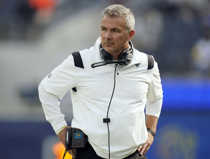 Jaguars head coach Urban Meyer stands on the field before an NFL football game.