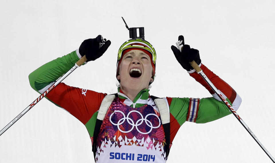 Belarus' Darya Domracheva celebrates winning the gold medal in the women's biathlon 12.5k mass-start, at the 2014 Winter Olympics, Monday, Feb. 17, 2014, in Krasnaya Polyana, Russia. (AP Photo/Kirsty Wigglesworth)