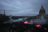 Protestors end the demonstration against plans to push back France's retirement age, at the Invalides monument, right, and the Eiffel Tower in background, Tuesday, Jan. 31, 2023 in Paris. Labor unions aimed to mobilize more than 1 million demonstrators in what one veteran left-wing leader described as a "citizens' insurrection." The nationwide strikes and protests were a crucial test both for President Emmanuel Macron's government and its opponents. (AP Photo/Thibault Camus)