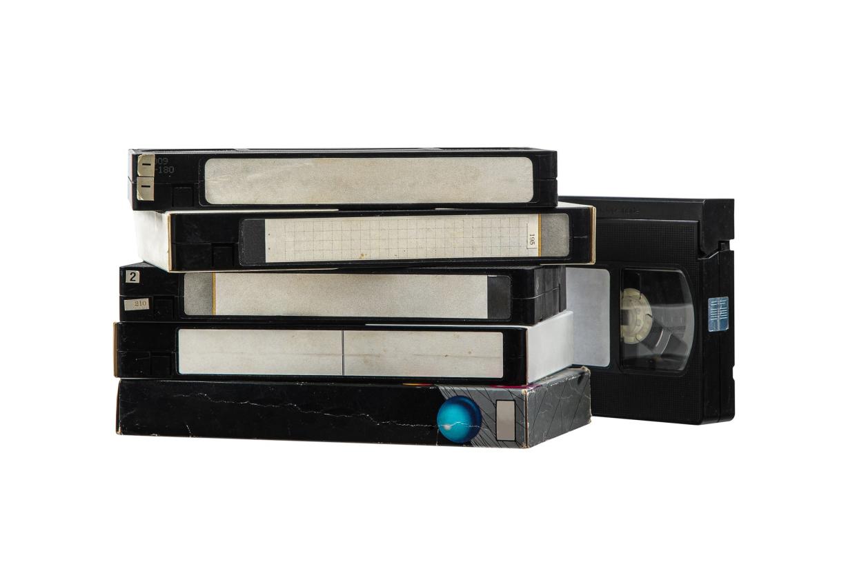 Pile of VHS video cassettes. Vintage media. Isolate on a white background.