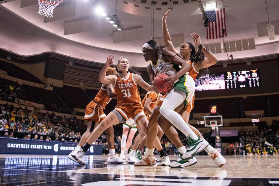 Texas defenders harass Baylor center Queen Egbo as she tries to work toward the basket during Sunday's Big 12 championship game at Municipal Auditorium in Kansas City, Mo.