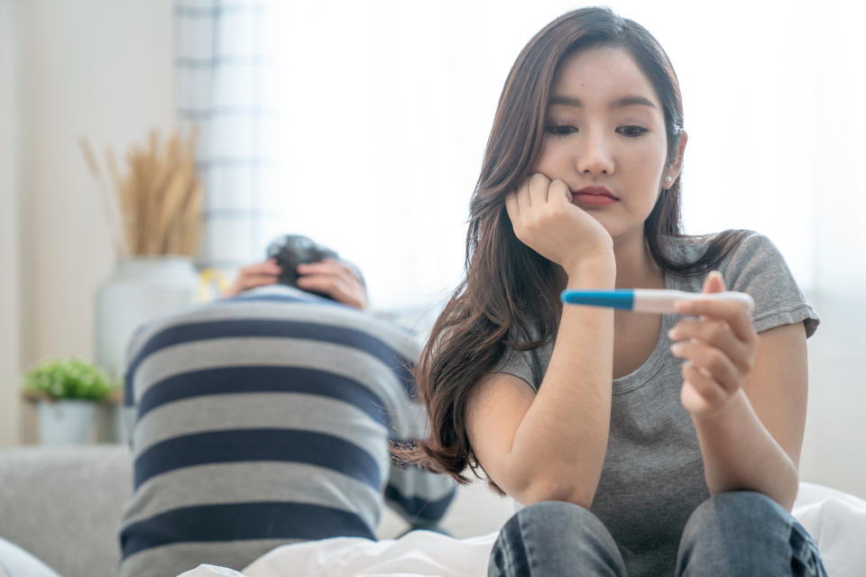 A women looks at the result of her pregnancy test.