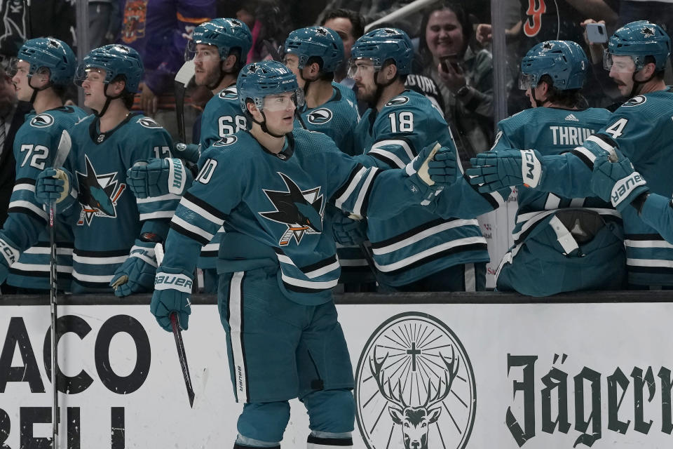 San Jose Sharks center Klim Kostin (10) is congratulated by teammates after scoring against the Seattle Kraken during the second period of an NHL hockey game in San Jose, Calif., Monday, April 1, 2024. (AP Photo/Jeff Chiu)