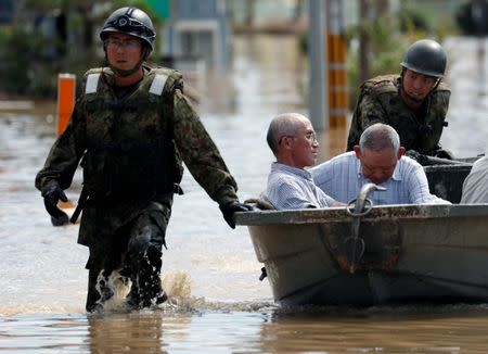 Japan Self-Defense Force soldiers rescue people from a flooded area in Mabi town in Kurashiki, Okayama Prefecture, Japan, July 8, 2018. REUTERS/Issei Kato