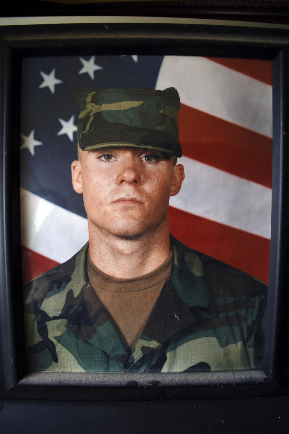 A photo of Army Ranger Spc. Jonn Edmunds, who along with another soldier died when a Black Hawk helicopter on a search-and-rescue mission crashed in Pakistan in October 2001, is seen in his father's home in Cheyenne, Wyo., Wednesday, Sept. 1, 2021. They were among the first U.S. casualties in the Afghanistan war. (AP Photo/Thomas Peipert)