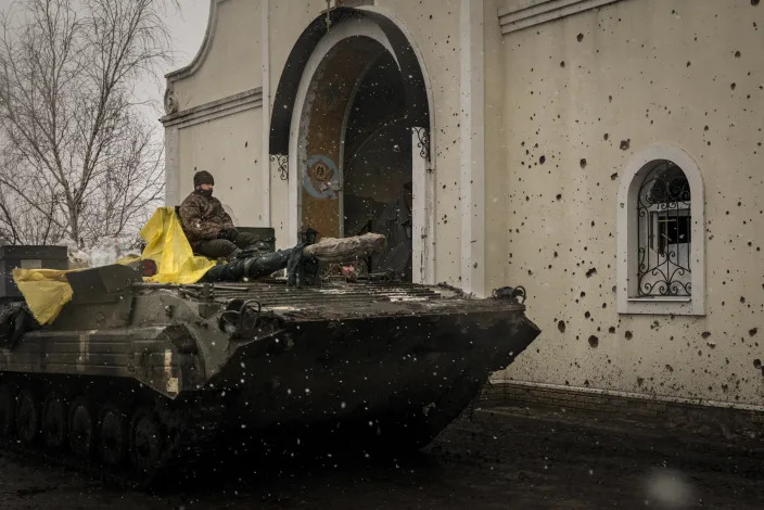A Ukrainian armored vehicle passes by a damaged church,  in the Donetsk region of Ukraine on Thursday, Jan. 5, 2023.  (Nicole Tung/The New York Times)