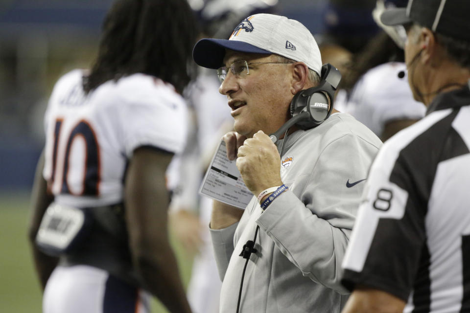 Denver Broncos head coach Vic Fangio wears a headset on the sideline during the first half of an NFL preseason football game against the Seattle Seahawks, Saturday, Aug. 21, 2021, in Seattle. (AP Photo/Jason Redmond)