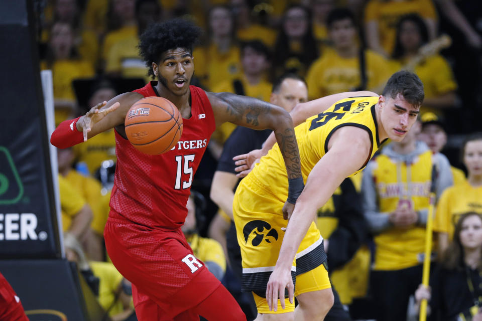 Rutgers center Myles Johnson (15) grabs a rebound in front of Iowa center Luka Garza during the first half of an NCAA college basketball game, Wednesday, Jan. 22, 2020, in Iowa City, Iowa. (AP Photo/Charlie Neibergall)