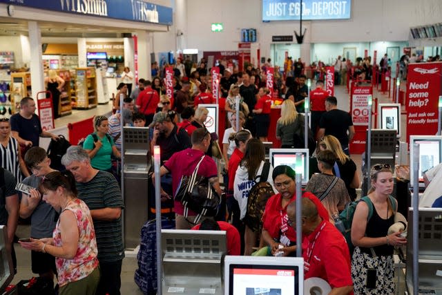 Passengers queue at Birmingham Airport