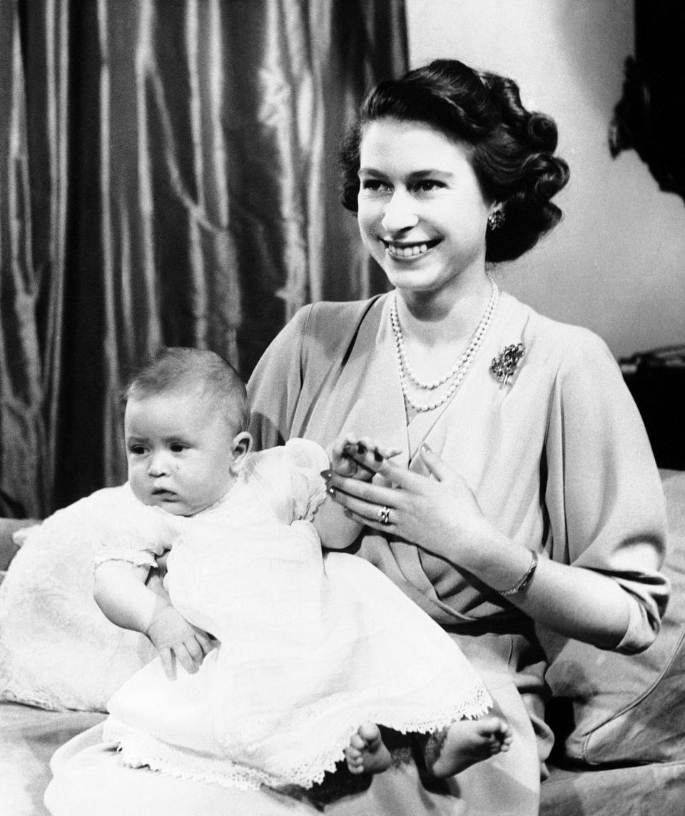FILE - Britain's Princess Elizabeth poses for a photo with her son, Prince Charles, in Buckingham Palace, London., April 10, 1949. After waiting 74 years to become king, Charles has used his first six months on the throne to meet faith leaders across the country, reshuffle royal residences and stage his first overseas state visit. With the coronation just weeks away, Charles and the Buckingham Palace machine are working at top speed to show the new king at work. (AP Photo, File)