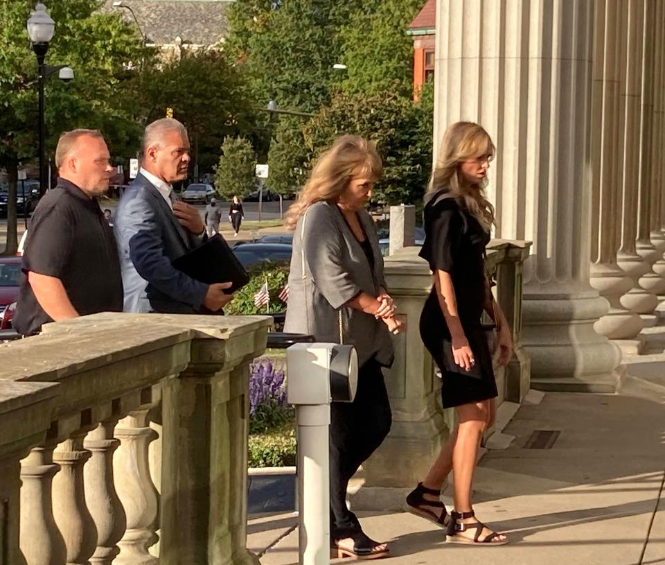 Haley E. Potter, far right, a former Erie TV news personality, walks into the Erie County Courthouse on Tuesday, for her sentencing on charges that she filed a false police report. She pleaded guilty and received two years of probation.